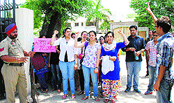 Interns at the Government Medical College protest outside the office of Cabinet Minster Anil Joshi to get their stipend released in Amritsar on Thursday