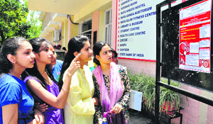Girls read a circular on the notice board at Guru Gobind Singh College for Women, Sector 26, in Chandigarh.
