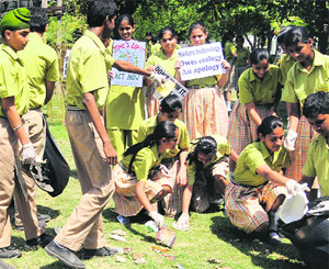 Students plant saplings on the occasion of World Environment Day at Tagore Theatre in Chandigarh.