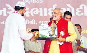 A file photograph of Narendra Modi receiving a memento after inaugurating a hospital set up by a Muslim trust