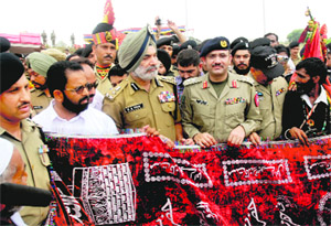 BSF officers accept a chaddar offered by Pakistan Rangers on the Zero Line in Chamliyal.