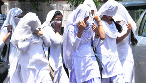 Students leave for home after attending their classes on the last day of school before the summer vacation in Jammu on Thursday.