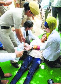A protesting girl falls unconscious during the protest outside Pal Auditorium at the PAU. 