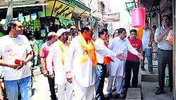 Activists of Rashtrawadi Shiv Sena ask shopkeepers to open their shops during a bandh call given by Sikh radical groups in Amritsar on Friday