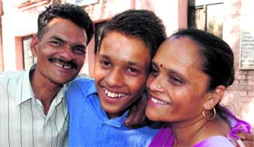 Sachin, who scored 97.4%, with his parents in Panchkula.