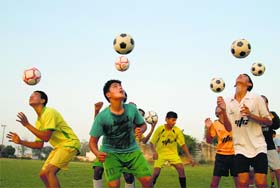 Football fever: Players of Youth Football Club (YFC) take part in a practice session at Rurka Kalan village in Jalandhar on Friday