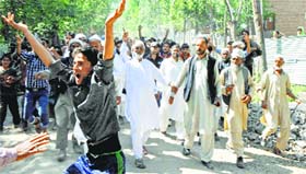 Protesters raise slogans during a rally, demanding the arrest of the stalkers who chopped off the ear of a girl at Dooru in Anantnag district on Friday.