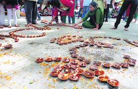 Pandits light diyas during the Kheer Bhawani festival at a temple in Tulla Mulla near Srinagar on Friday.