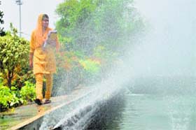 Beat the heat: With the day temperature hovering around 45 degrees in Ludhiana, a girl feels cool breeze near a fountain at the PAU