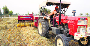 A baler machine at work in a field. 
