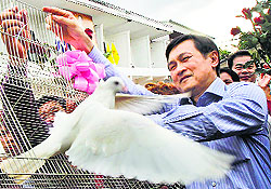 Former Thailand Education Minister Chaturon Chaisang frees pigeons after he was released from Bangkok's Remand Prison on Friday