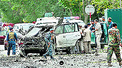 Afghan policemen investigate the site of a suicide attack in Kabul on Friday. Reuters
