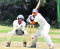 A batsman plays a shot during a match in the All India Gold Cup cricket tournament at the Rangers College ground in Dehradun on Saturday.