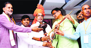 BJP Kisan Morcha president Om Prakash Dhankar presents a hookah to Union Agriculture Minister Radha Mohan Singh at Bahadurgarh in Jhajjar district on Saturday.