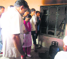Forensic experts look for clues at the victims house in Rangruti Kehra village in Karnal district on Saturday morning.