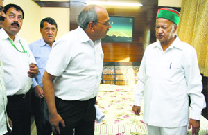Chief Minister Virbhadra Singh with officials of Himachal Bhawan in New Delhi on Friday evening.