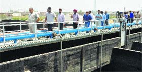 Punjab Sewerage Board Chairman Vinod Kumar and Mayor Sunil Jyoti review a sewage treatment plant at Basti Peer Daad in Jalandhar on Saturday.