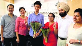 Shung Ming Chiu (rank 26) and Puneet Kaur (rank 31) with their parents.