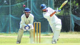 A local batsman strikes the ball as the Amritsar wicket-keeper watches during an inter-district match in Ludhiana on Saturday.