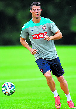 Portugals Cristiano Ronaldo kicks a ball taking laps during training in Florham Park, New Jersey.