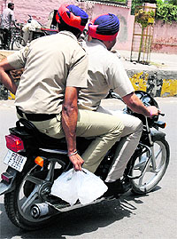 cooling off: Policemen carry ice to beat the heat in Bathinda on Sunday. 