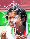 A tennis player cools herself off during a break in a qualifying round match of a tournament at the CLTA, Chandigarh, on Sunday