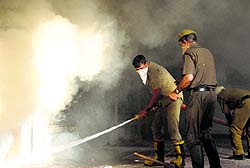 Firemen try to douse the flames in the building