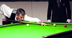 Peter Gilchrist of Singapore strikes a shot during the snooker championship at the UT Guest House in Chandigarh on Sunday