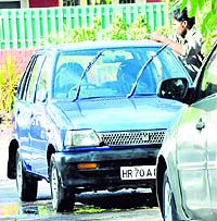 A worker washes a car