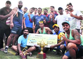 ONGC players celebrate with the trophy after winning the All India Gold Cup cricket tournament at Ranjers Ground in Dehradun on Sunday