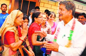 Chief Minister Harish Rawat meets women of his native village, Manohari, in Almora district on Sunday