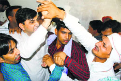 Congress workers push each other during a party meeting in Hisar on Sunday. 