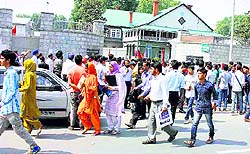 Students come out of a college in Srinagar after appearing in a state-level Common Entrance Test for various medical and engineering undergraduate courses on Sunday