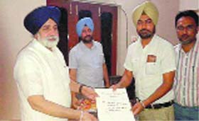 Punjab Education Minister Sikander Singh Maluka receives a charter of demands from the SSA and the RMSA teachers in Bathinda on Monday.