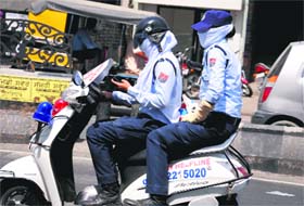 A WASP personnel checks her mobile phone while riding in Bathinda on Monday.