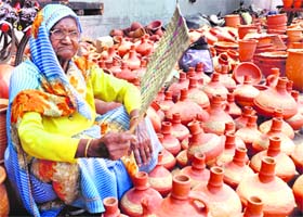 Old is gold: An old lady with her earthen pots in Dehradun. Despite increase in demand of fridges and water coolers, earthen pots are still a favourite among people