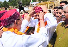 ROUSING WELCOME: Chief MInister Harish Rawat being given a traditional cap by Assembly Speaker Govind Singh Kunjwal during the inauguration of the Assembly session at Gairsain on Monday