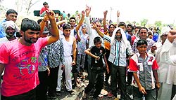 Infuriated over erratic power supply, villagers disrupt traffic on the national highway-10 near Madina village in Rohtak on Monday