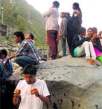 A group of students on a rock in the Beas moments before 24 of them were washed away in the water released from the Larji dam at Thalot on Sunday