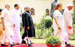 President Pranab Mukherjee (C) arrives with PM Narendra Modi to address the joint session of Parliament in New Delhi