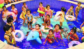 Children enjoy a pool party to keep themselves cool in the scorching heat