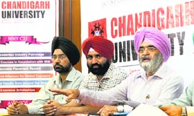 Vice-Chancellor of Chandigarh University RS Bawa (in pink turban) addresses a press conference in Ludhiana on Monday