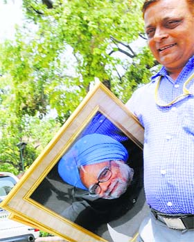 Carting away to history: A portrait of former Prime Minister Manmohan Singh being removed from Parliament House in New Delhi on Monday