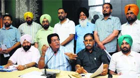 Punjab Motor Union president Avtar Henry (centre) at a press conference along with other members of the union in Chandigarh on Monday.