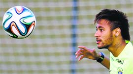Brazil's forward Neymar watches the ball closely during a training session ahead of the World Cup.