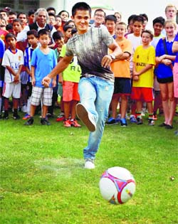 Indian football team captain Sunil Chhetri kicks a ball during launch of an ebook on World Cup Football at the German embassy in New Delhi on Monday.