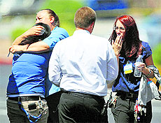 Walmart employees hug outside their store after shootings at the store and a nearby CiCis Pizza in Las Vegas on Sunday. 