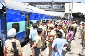Railway Protection Force and General Railway Police personnel pacify protesting passengers of the Swaraj Express at the Jammu railway station on Tuesday