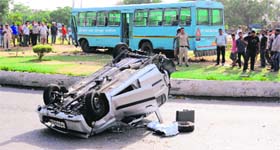 An overturned car and a Haryana Roadways Bus at the Attawa roundabout in Sector 42, Chandigarh, on Wednesday.