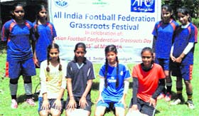 Budding soccer female players at a football camp.